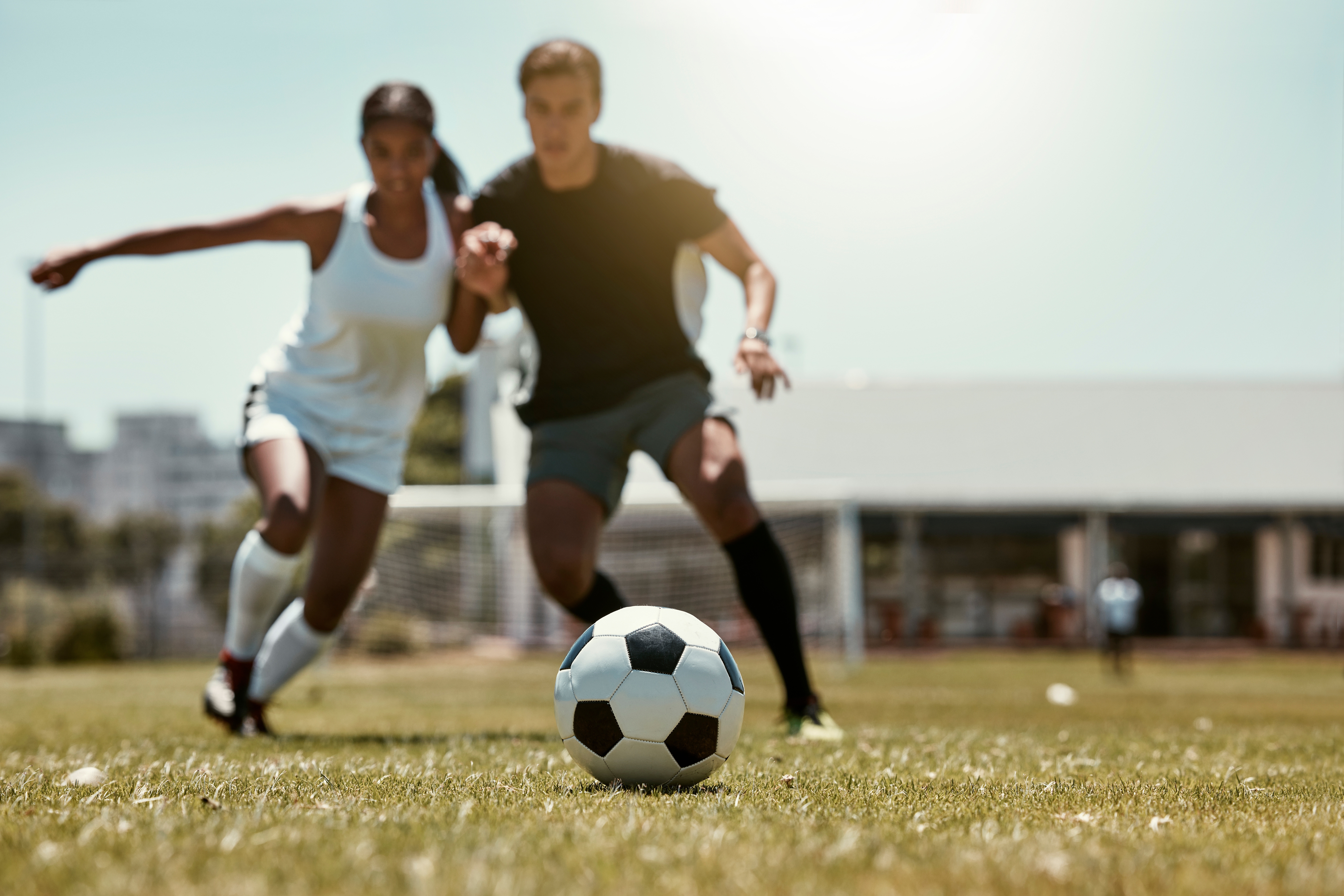Man and women play soccer together